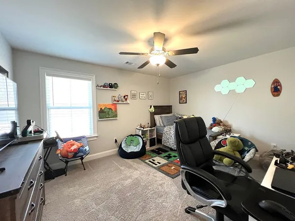 a bathroom with a granite countertop sink a toilet and a mirror