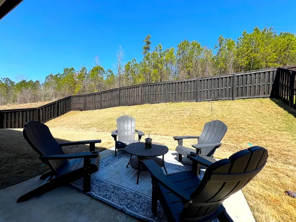 a view of a backyard with table and chairs