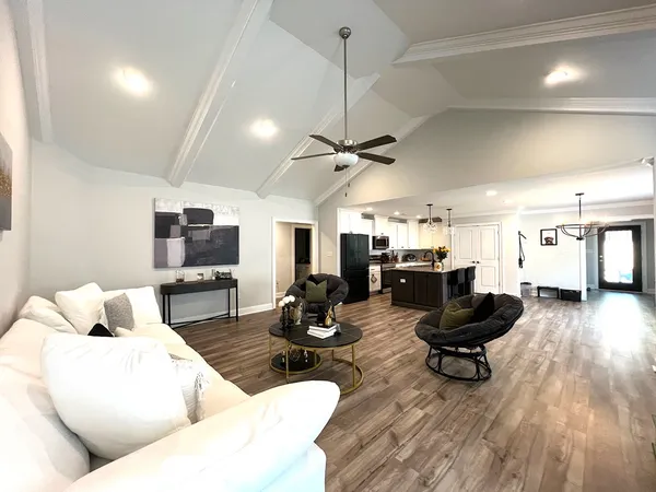 a living room with furniture a fireplace and a flat screen tv