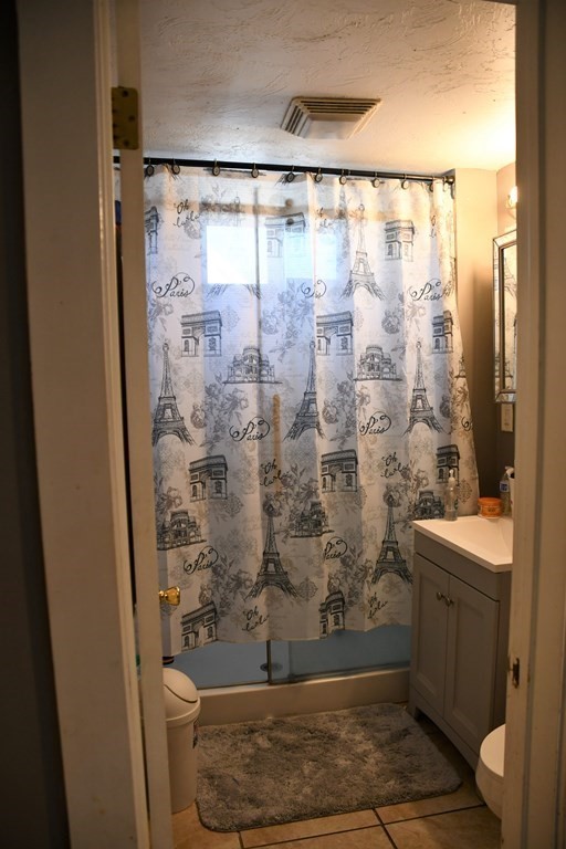 12-14 Longview Street Springfield, MA 01108 - Photo 26 of 42 a bathroom with a shower a toilet and a shower