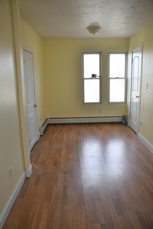 12-14 Longview Street Springfield, MA 01108 - Photo 33 of 42 an empty room with wooden floor and windows