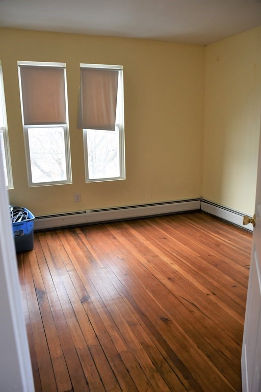 12-14 Longview Street Springfield, MA 01108 - Photo 36 of 42 a view of an empty room with wooden floor and a window