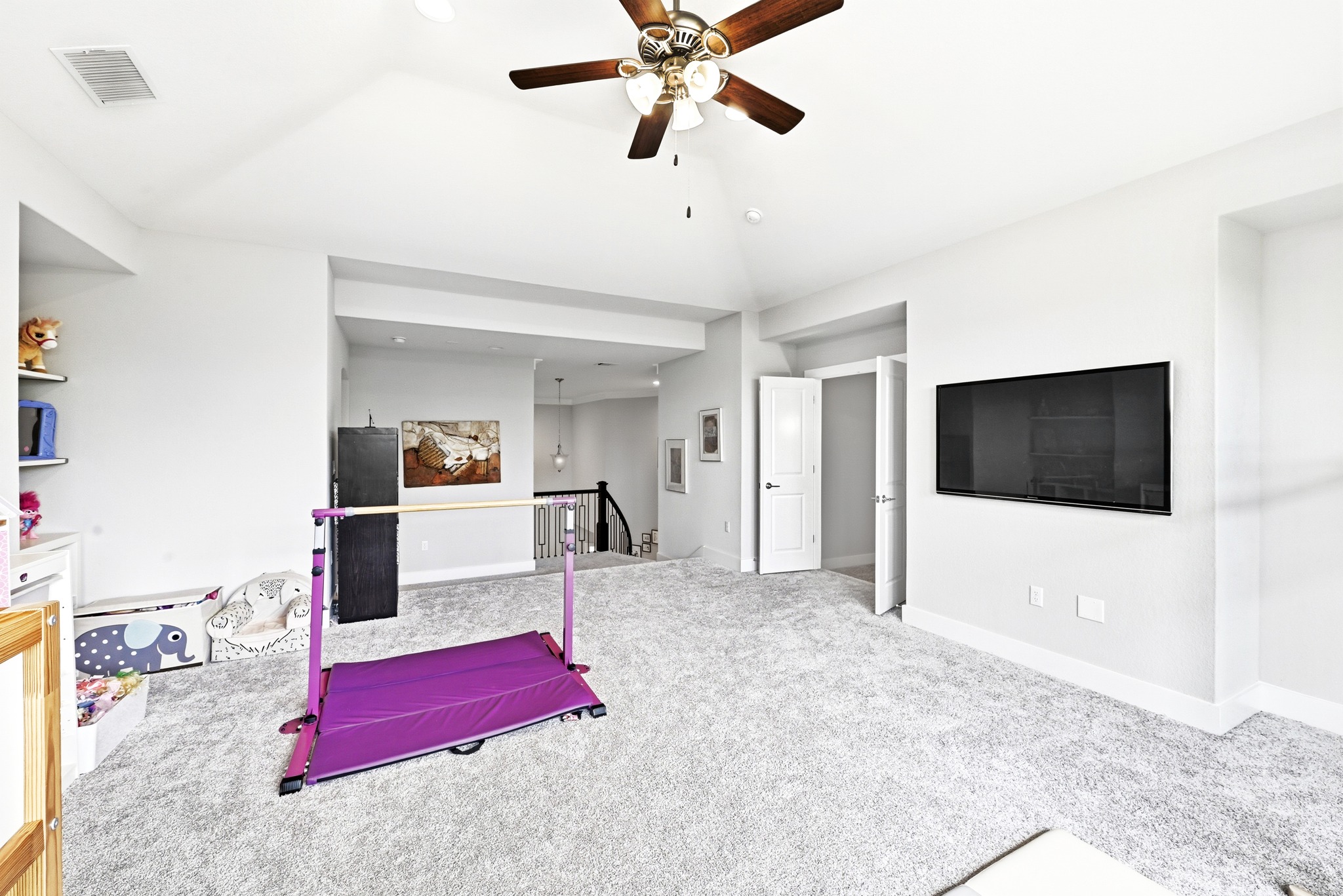 9008 Harper Rae Drive Austin, TX 78717 - Photo 24 of 39 Spacious room with vaulted ceilings and light grey carpeting, featuring a ceiling fan, white baseboards, and an open doorway