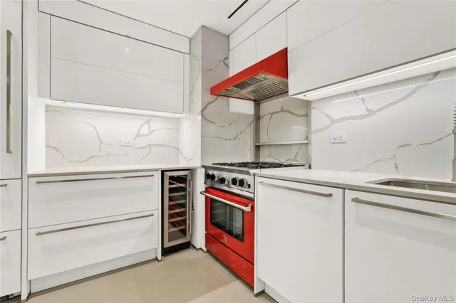 a kitchen with stainless steel appliances granite countertop a stove and a refrigerator