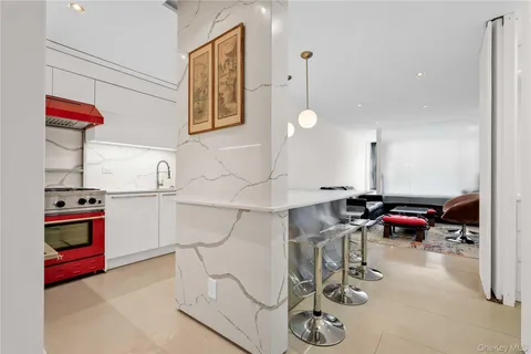 a kitchen with stainless steel appliances kitchen island granite countertop a sink and cabinets