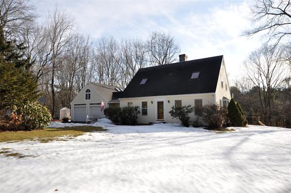 a view of a house with a yard covered in snow