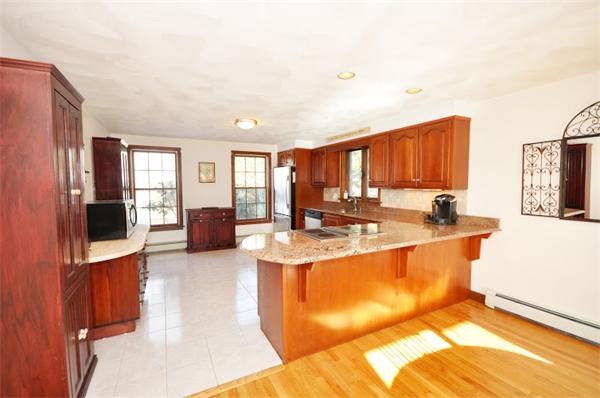 130 Stow Road Boxborough, MA 01719 - Photo 6 of 19 a large kitchen with stainless steel appliances granite countertop a sink stove and refrigerator