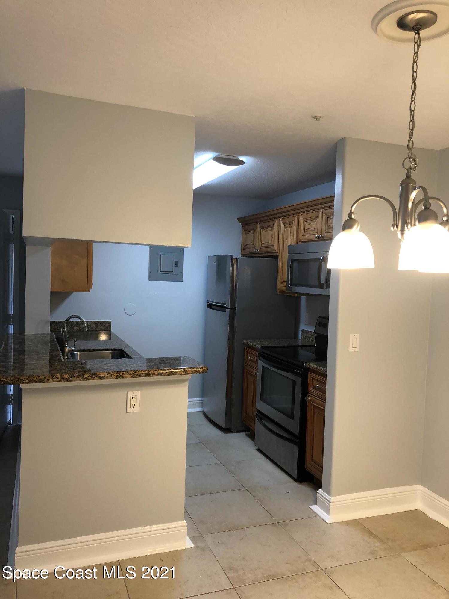 7667 North Wickham Road, Unit 406 Melbourne, FL 32940 - Photo 17 of 28 KITCHEN AND DINNING ROOM