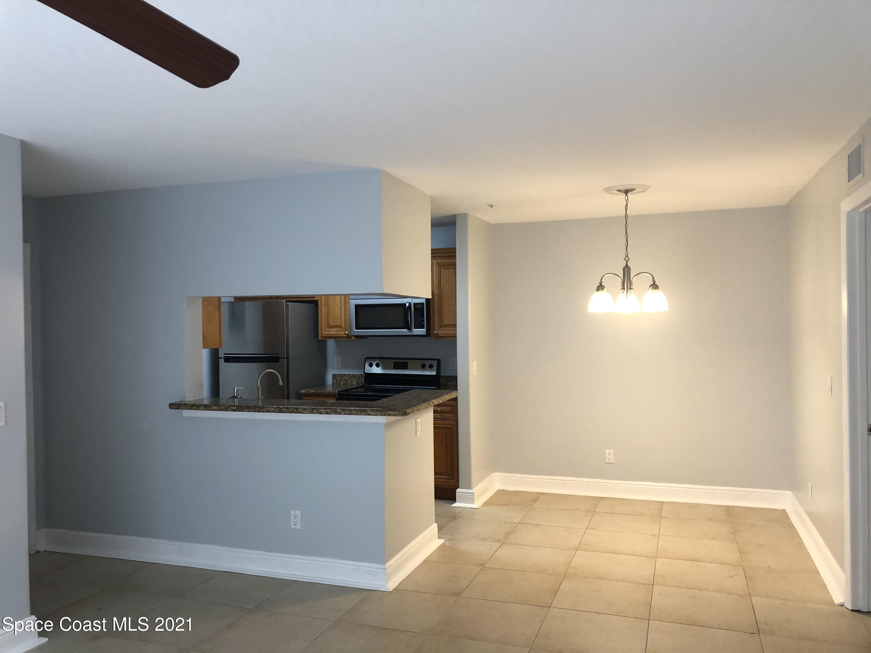 7667 North Wickham Road, Unit 406 Melbourne, FL 32940 - Photo 9 of 28 LIVING DINING KITCHEN