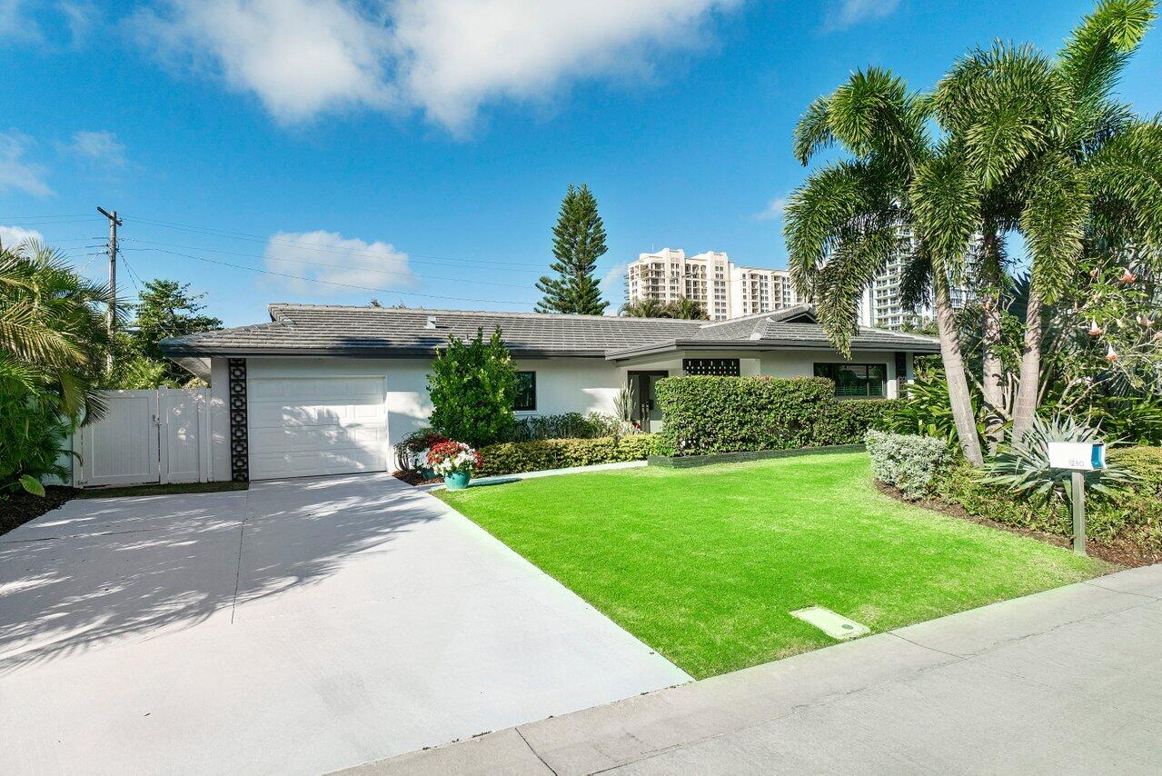 a front view of a house with a garden and plants