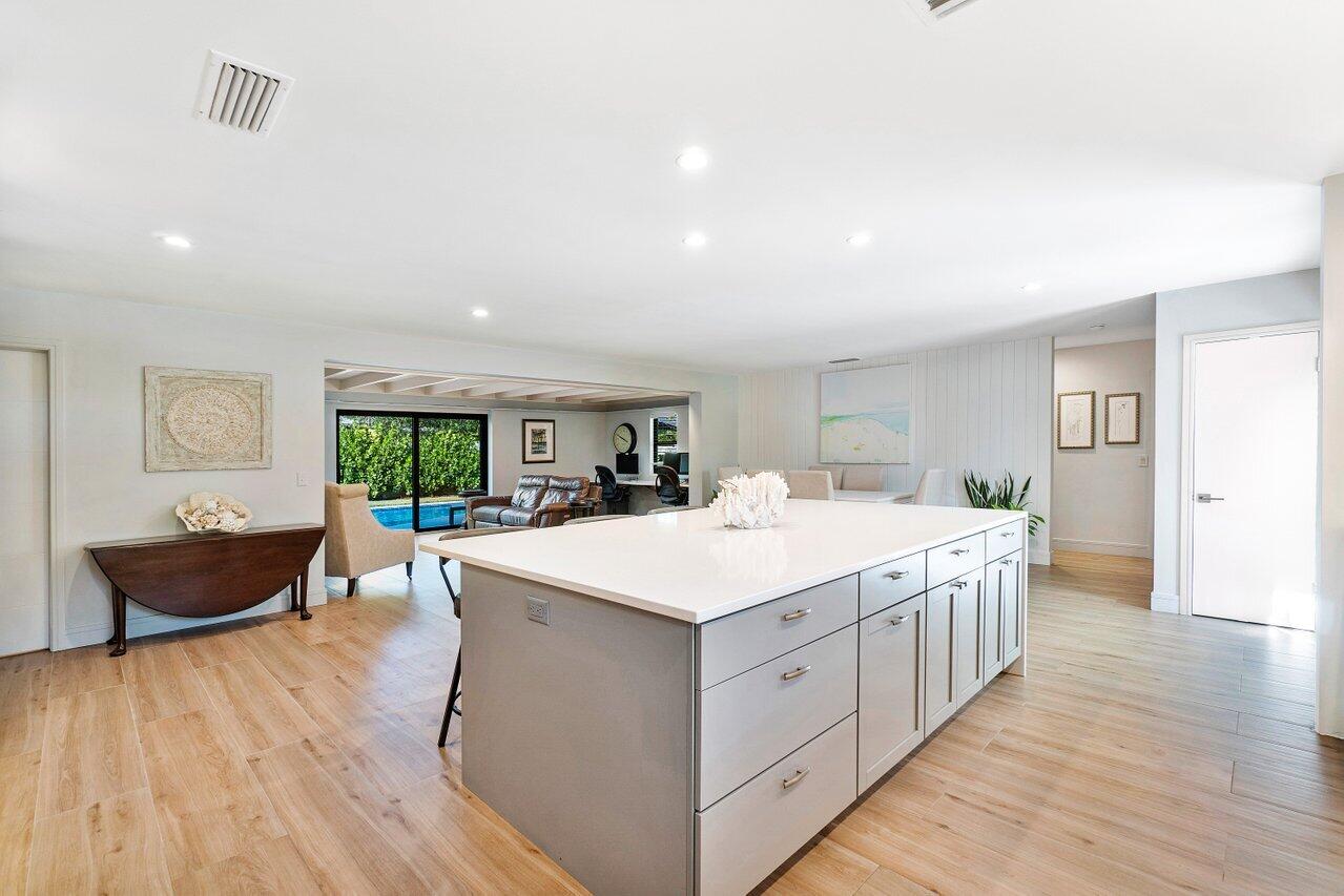 1280 Singer Drive Singer Island, FL 33404 - Photo 11 of 39 a large white kitchen with wooden floor