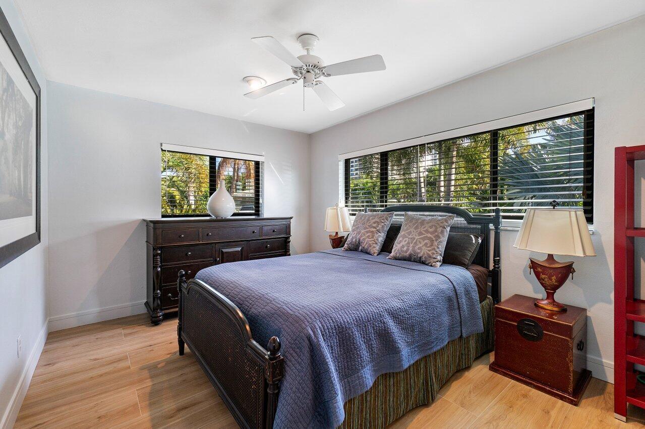 1280 Singer Drive Singer Island, FL 33404 - Photo 12 of 39 a bedroom with a bed and wooden floor