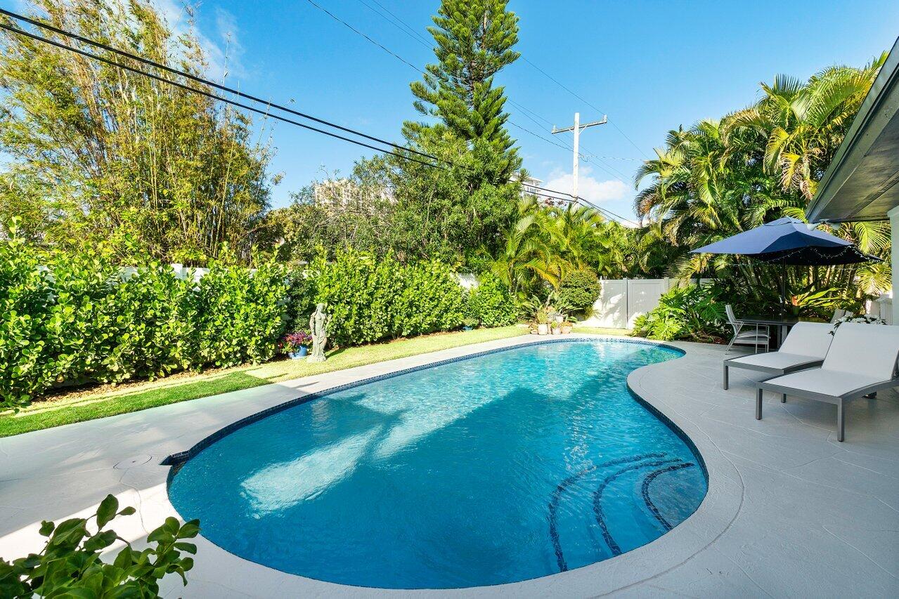1280 Singer Drive Singer Island, FL 33404 - Photo 21 of 39 a view of a swimming pool with a sitting area