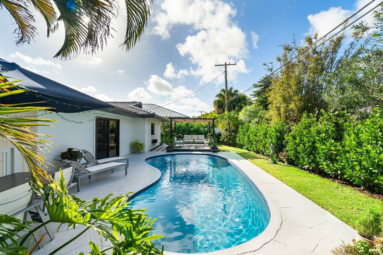 1280 Singer Drive Singer Island, FL 33404 - Photo 23 of 39 a view of a swimming pool with a patio