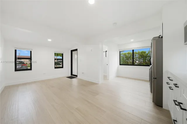 a kitchen with stainless steel appliances a refrigerator sink and stove