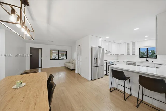 a kitchen with stainless steel appliances a refrigerator and a stove