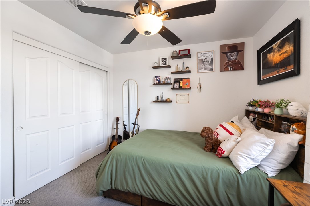 1941 Ivy Point Lane Las Vegas, NV 89134 - Photo 16 of 21 This restful bedroom features a sliding door closet and a ceiling fan for optimal comfort.