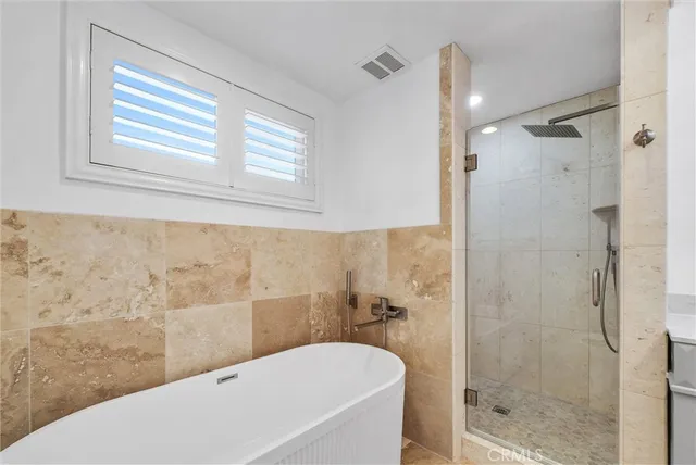 a bathroom with a bathtub and shower