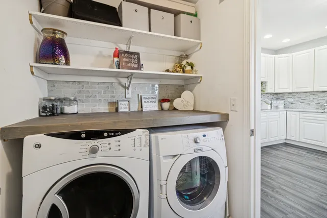 a utility room with sink dryer and washer