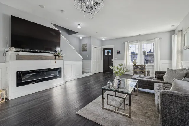 a living room with furniture fireplace and flat screen tv