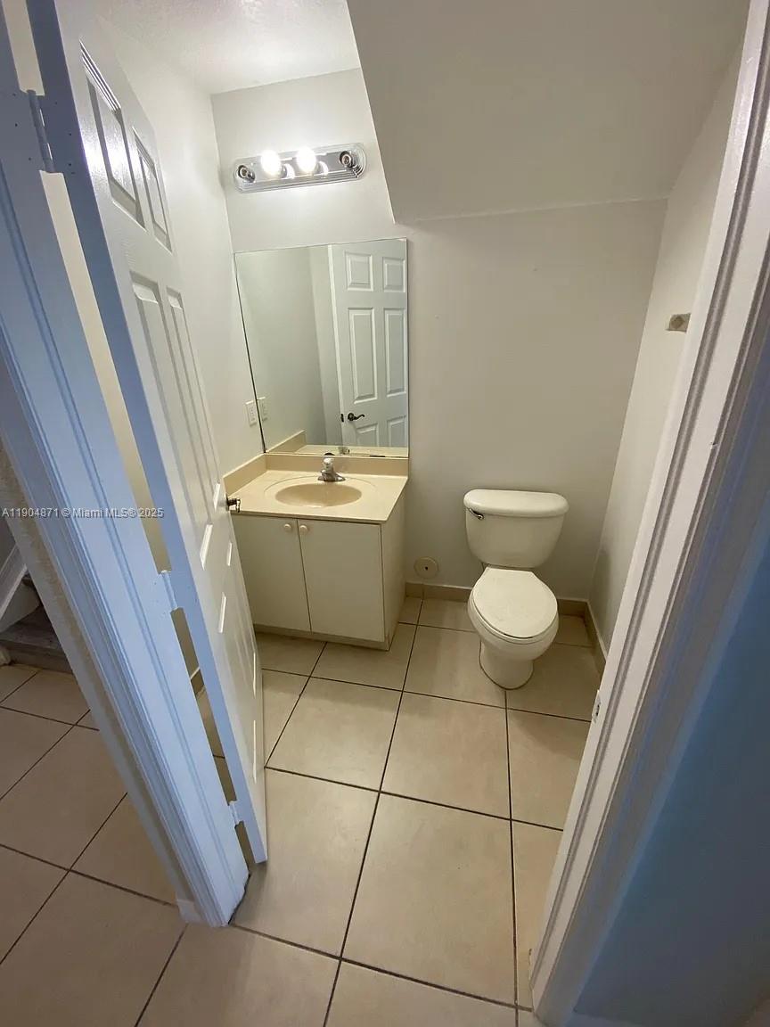 4947 Southwest 135th Way Miramar, FL 33027 - Photo 14 of 17 a bathroom with a granite countertop sink and a mirror