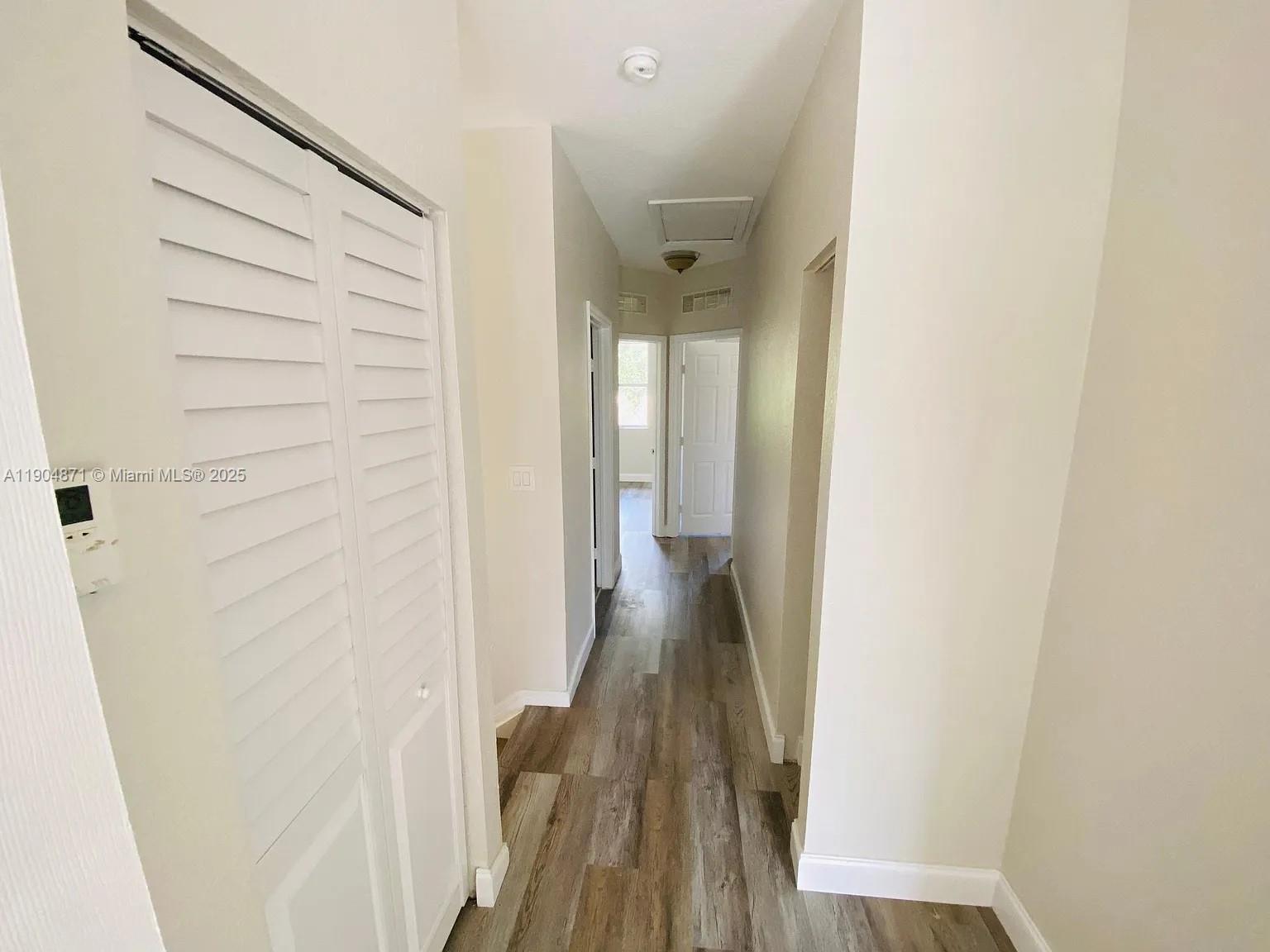 4947 Southwest 135th Way Miramar, FL 33027 - Photo 15 of 17 a view of a hallway with wooden floor and staircase