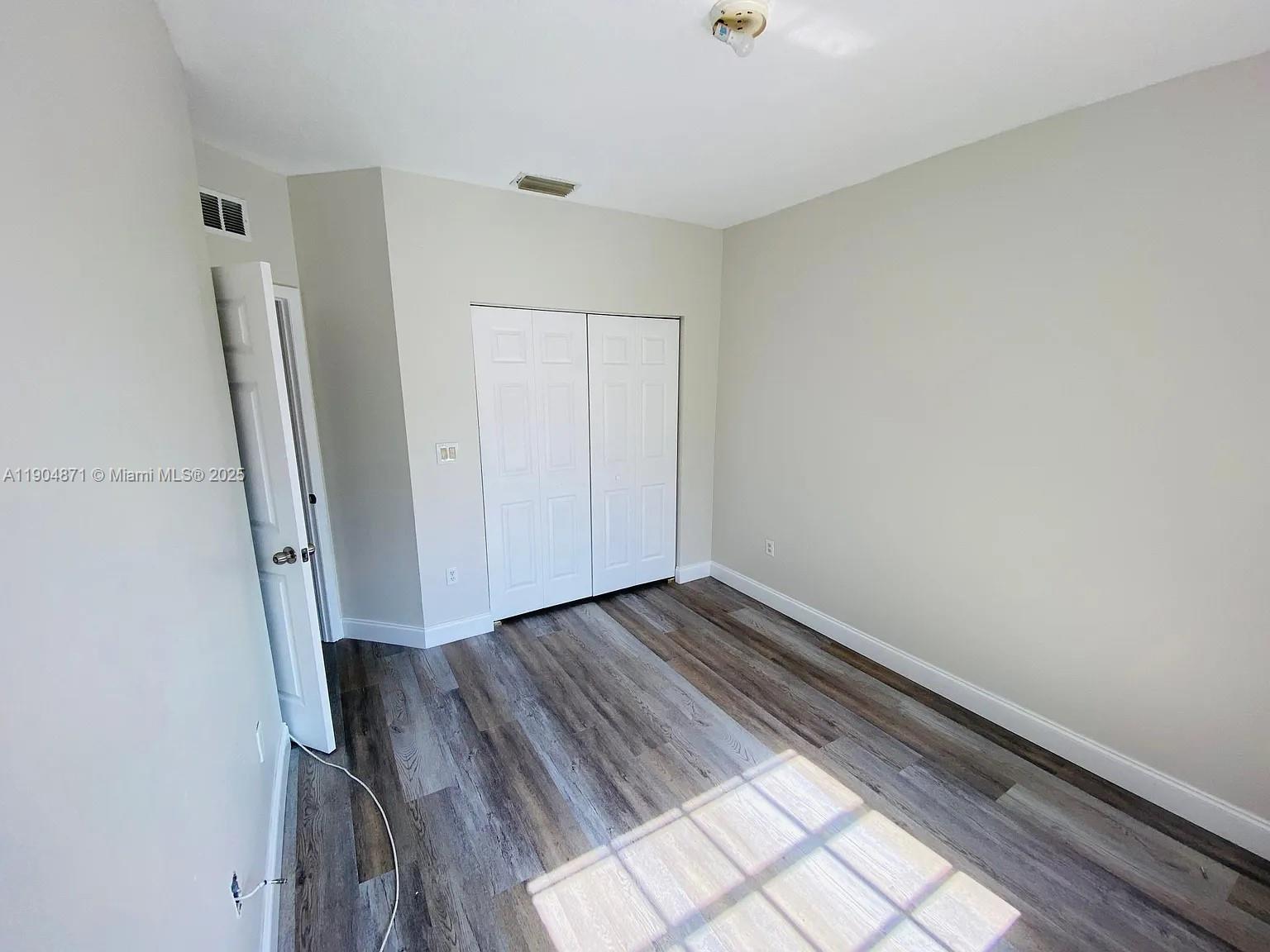 4947 Southwest 135th Way Miramar, FL 33027 - Photo 4 of 17 a view of a room with wooden floor and staircase