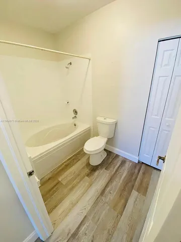 a bathroom with a white toilet and a shower