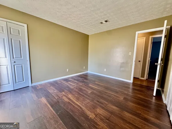a view of a room with wooden floor and stairs