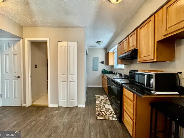a kitchen with stainless steel appliances granite countertop a stove refrigerator sink and cabinets