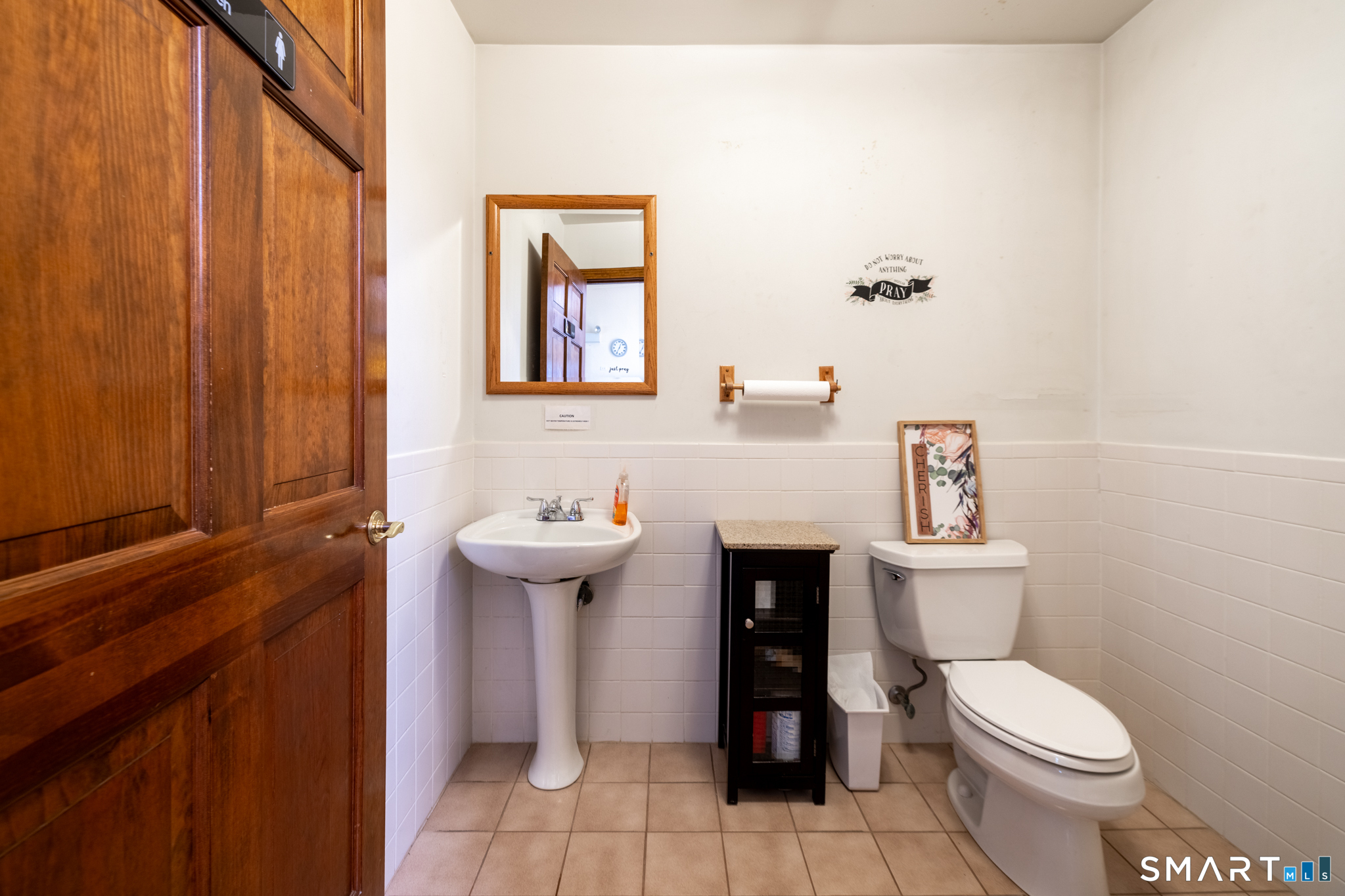 523 West Street Bristol, CT 06010 - Photo 17 of 30 a bathroom with a toilet a sink and mirror