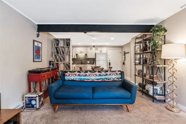a room with lots of different furniture and a chandelier