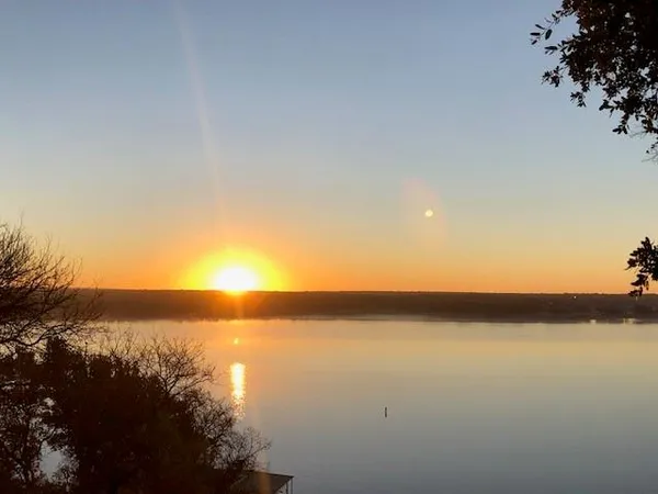 a view of lake with sunset