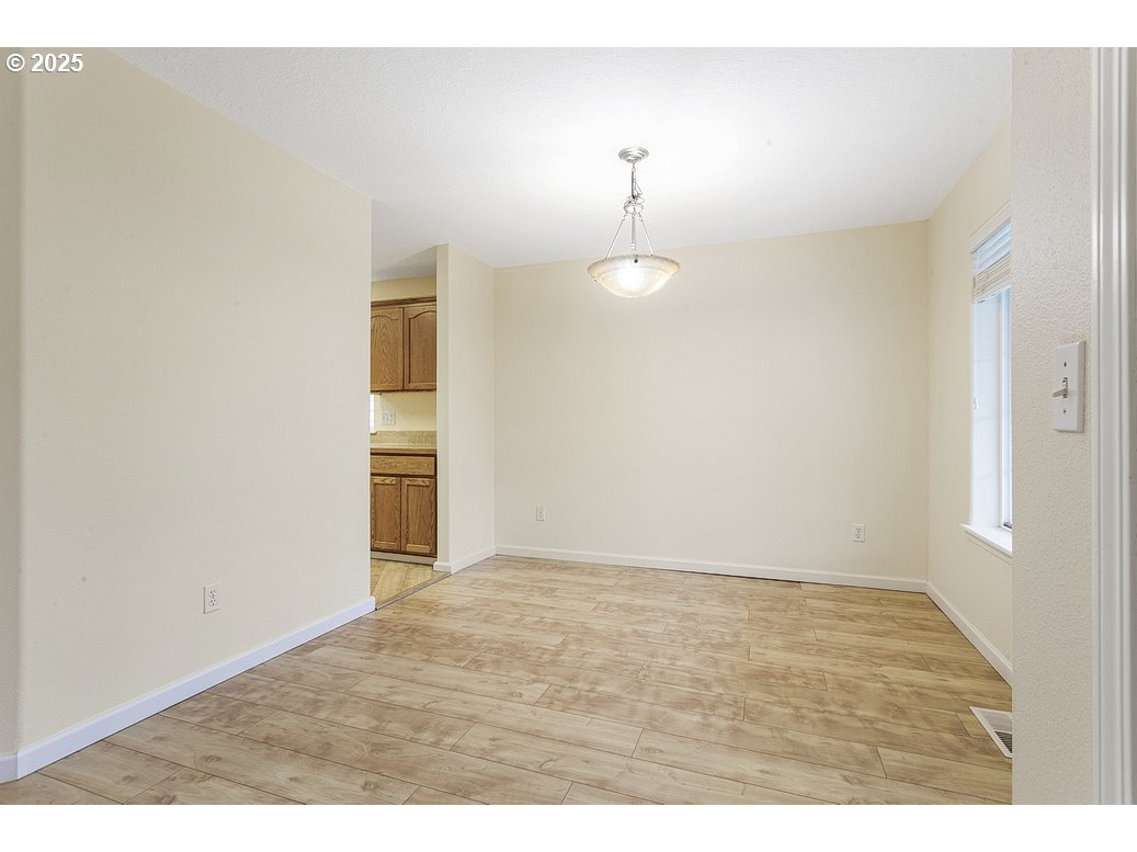 1575 Southeast Dexter Lane Gresham, OR 97080 - Photo 14 of 48 a view of an empty room with wooden floor