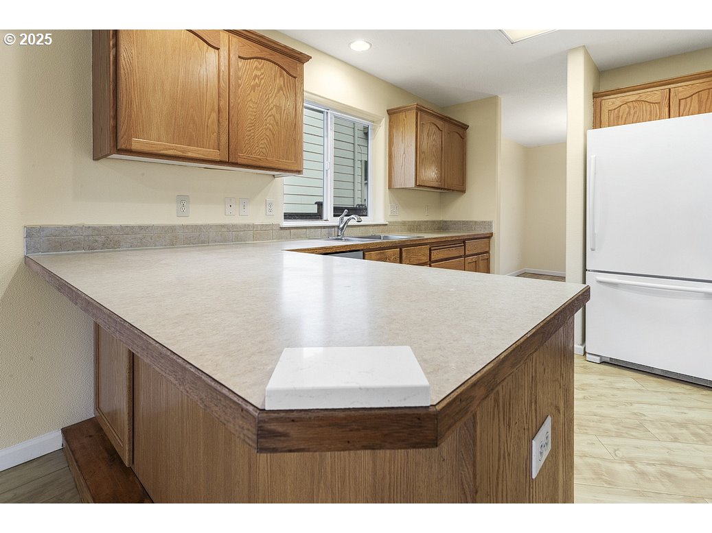 1575 Southeast Dexter Lane Gresham, OR 97080 - Photo 20 of 48 a kitchen with stainless steel appliances granite countertop a sink a refrigerator and a stove