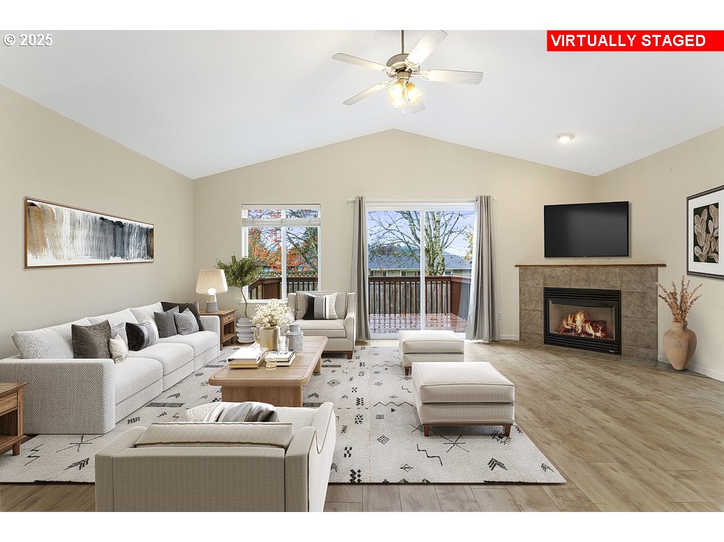 1575 Southeast Dexter Lane Gresham, OR 97080 - Photo 3 of 48 a living room with furniture a fireplace and a flat screen tv