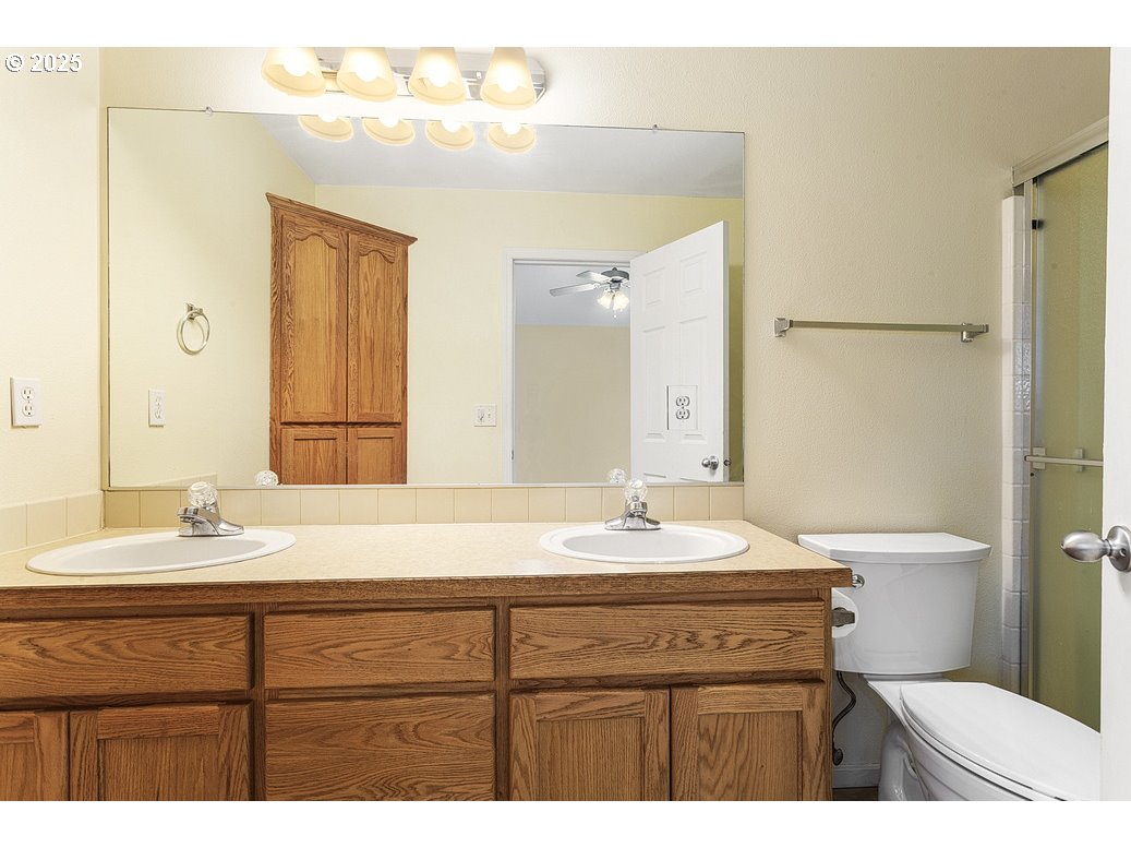 1575 Southeast Dexter Lane Gresham, OR 97080 - Photo 35 of 48 a bathroom with a sink a toilet and a mirror