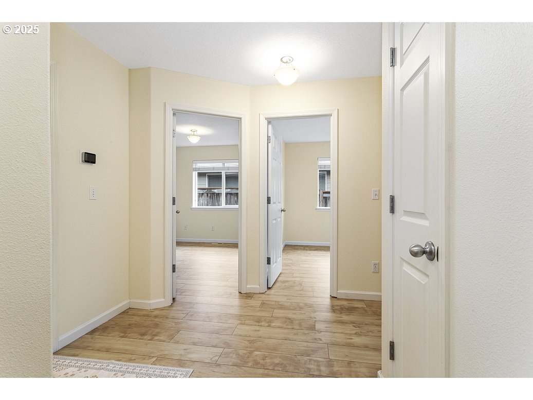 1575 Southeast Dexter Lane Gresham, OR 97080 - Photo 36 of 48 a view of a hallway with wooden floor and closet area
