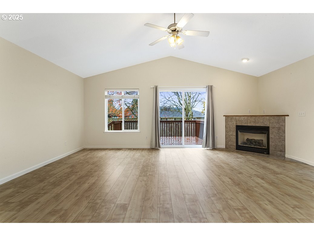 1575 Southeast Dexter Lane Gresham, OR 97080 - Photo 4 of 48 an empty room with windows and fireplace