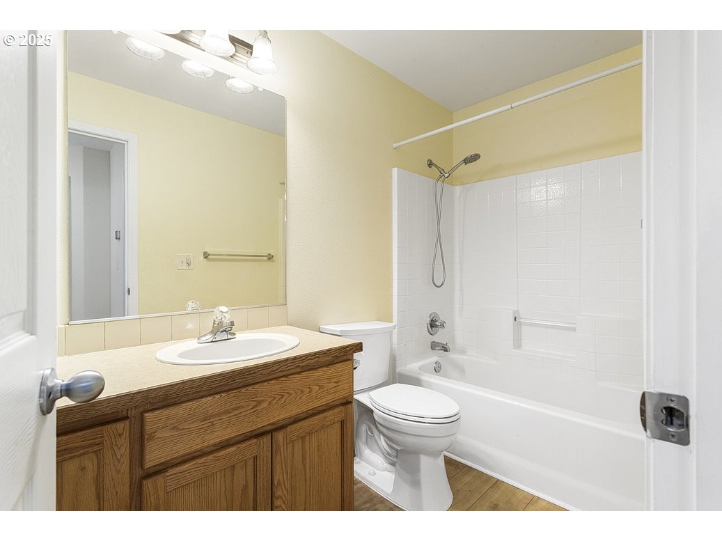 1575 Southeast Dexter Lane Gresham, OR 97080 - Photo 41 of 48 a bathroom with a sink a toilet a mirror a bathtub and shower