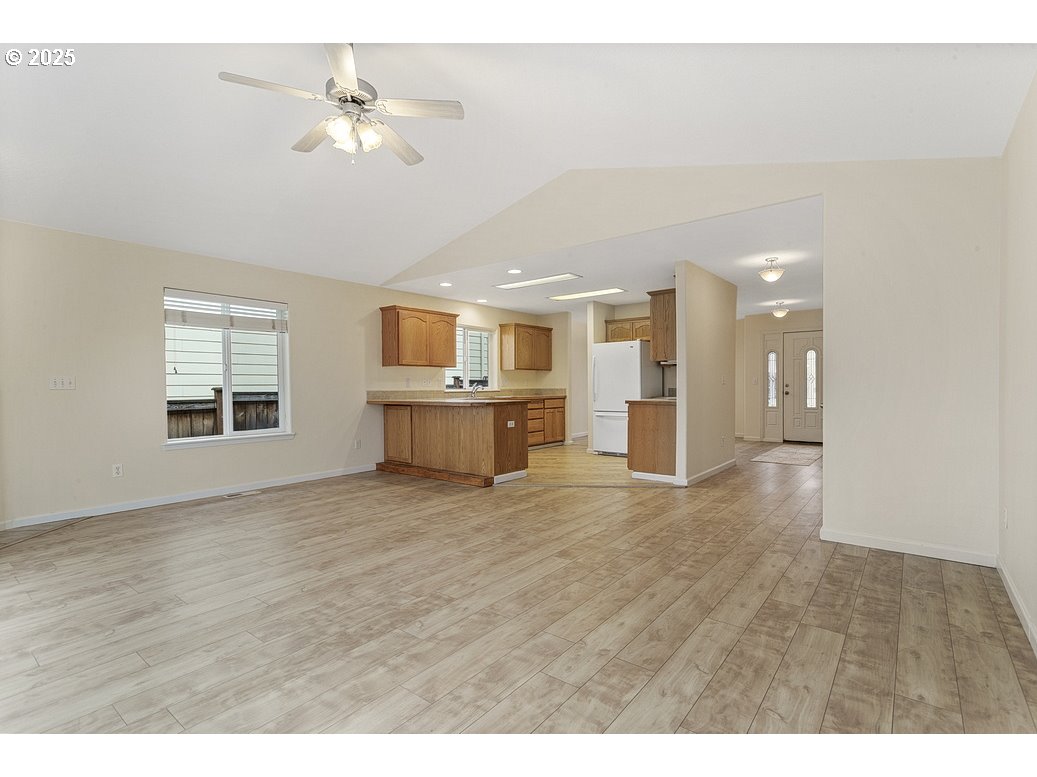 1575 Southeast Dexter Lane Gresham, OR 97080 - Photo 8 of 48 a view of an empty room with a window and a kitchen