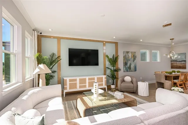 a bedroom with a balcony a bed and a chandelier