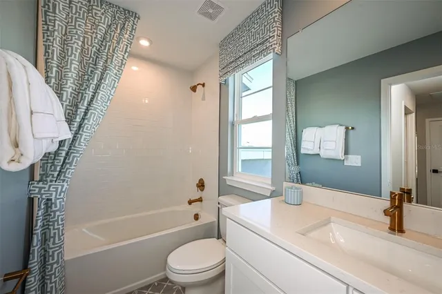 a view of a living room and floor to ceiling window or kitchen