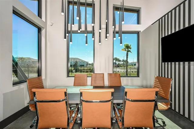 a view of a workspace with furniture and a window