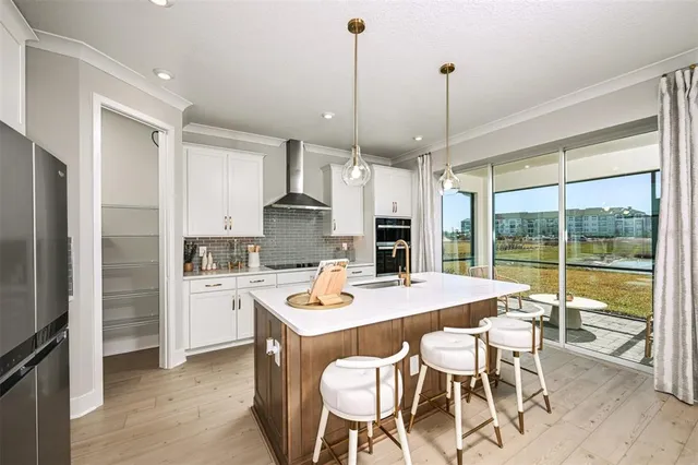 a kitchen with stainless steel appliances a sink stove and refrigerator
