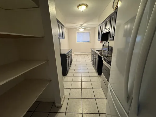 a kitchen with stainless steel appliances a refrigerator sink and stove