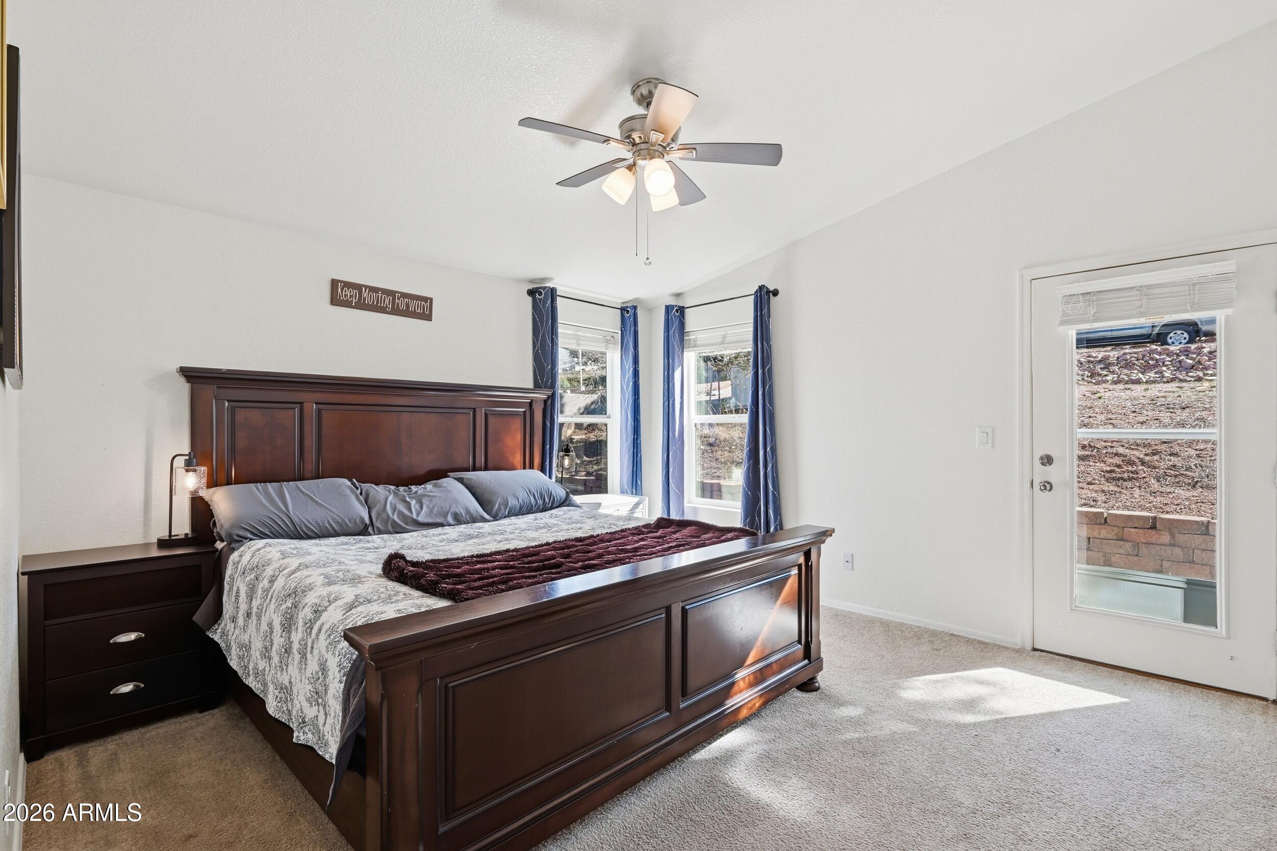 206 East Pine Street Payson, AZ 85541 - Photo 11 of 30 a bed sitting in a bedroom next to a window and a chandelier