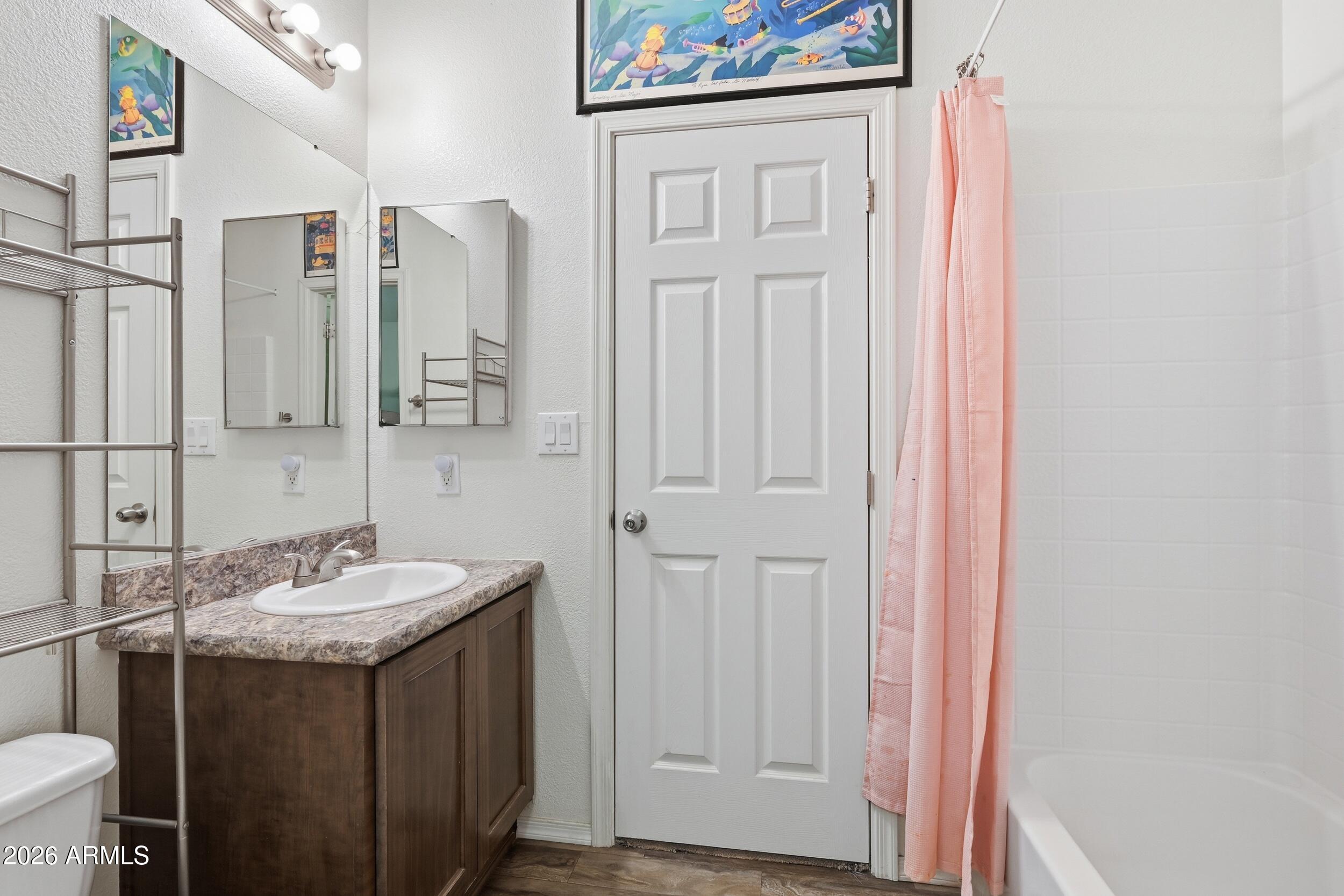 206 East Pine Street Payson, AZ 85541 - Photo 17 of 30 a bathroom with a granite countertop sink and a mirror
