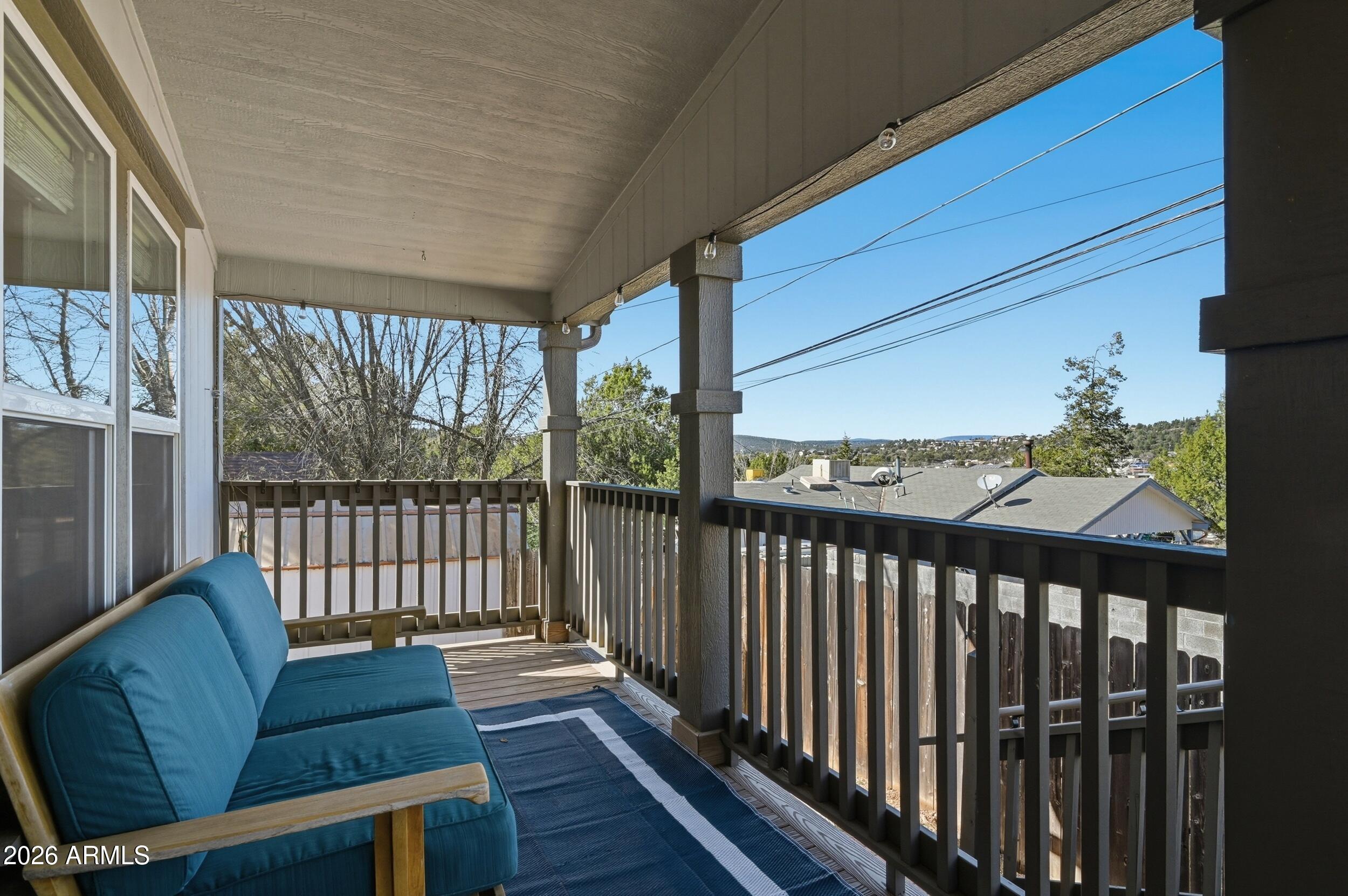 206 East Pine Street Payson, AZ 85541 - Photo 25 of 30 a balcony with wooden floor table and chairs
