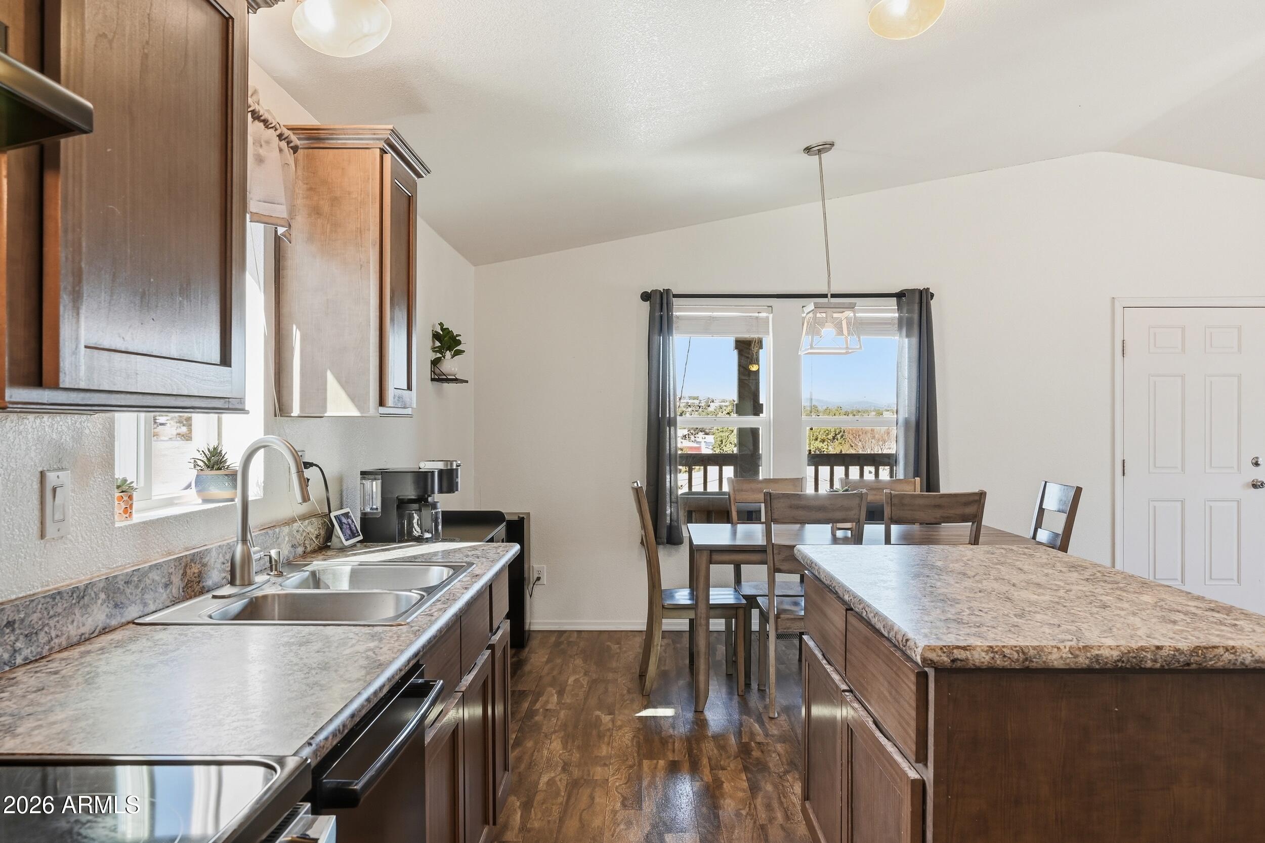 206 East Pine Street Payson, AZ 85541 - Photo 9 of 30 a kitchen with granite countertop a table chairs stove and kitchen island